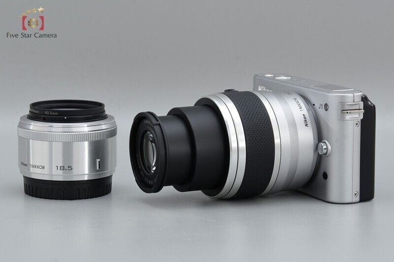 "Count 4,286" Nikon 1 J1 Silver 10.1 MP Digital Camera + Double Lens Kit